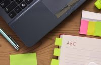 Desk with notepads and laptop