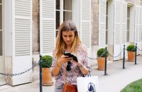 Girl with shopping bags, texting