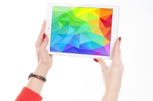 a woman holding an IPad