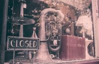 A closed sign in front of a musical instrument store